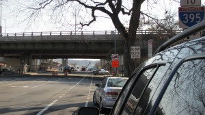 A car turns right just after the underpass onto the access ramp