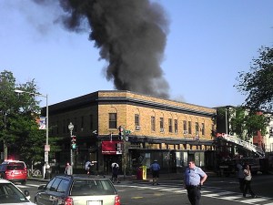 Early photo of the fire showing people still in front of the store