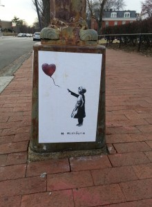 Last week, posters created by elusive graffiti artist Banksy, began appearing on Capitol Hill.  The posters created to show solidarity with the rebels against the Syrian government, commemorate the third anniversary of the beginning of the Syrian conflict – March 15, 2011.  