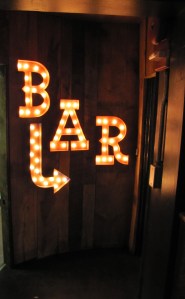 Electric Lights Point the Way to the Elixer Bar on the Lower Lever