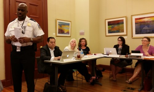 Commander Jeff Brown, 1D MPD.  Seated, left to right, Commssioners Chao, Samolyk, Hoskins, and Chair Oldenburg.