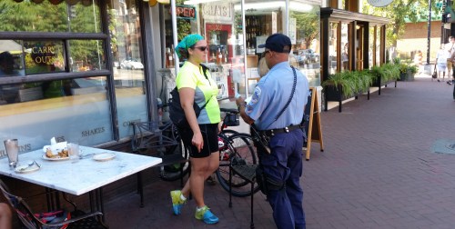 Officer G.L. Brown listens as a Brookland resident describes the attempted bike theft. The bikes were leaning against the table in the photo while the owner sat at the table. 