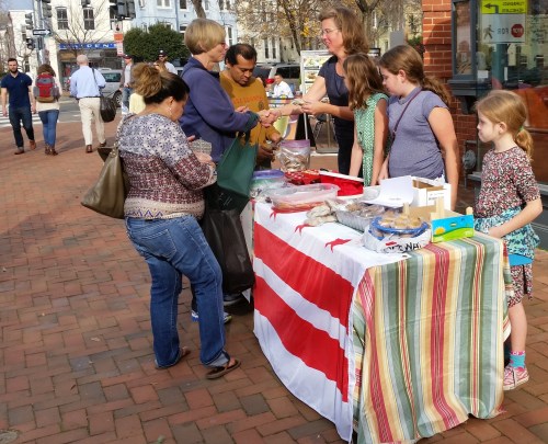 ANC6B10  Commissioner Denise Krepp and helpers at today's bake sale at Eastern  Market.  The fund raiser was for the fee DOJ charges to release prosecution statistics for DC.  Krepp said that she choose a bale sale rather than pursuing a waiver or other funding options  in order to call attention to DOJ's and the US Attorney's office lack of transparency.  