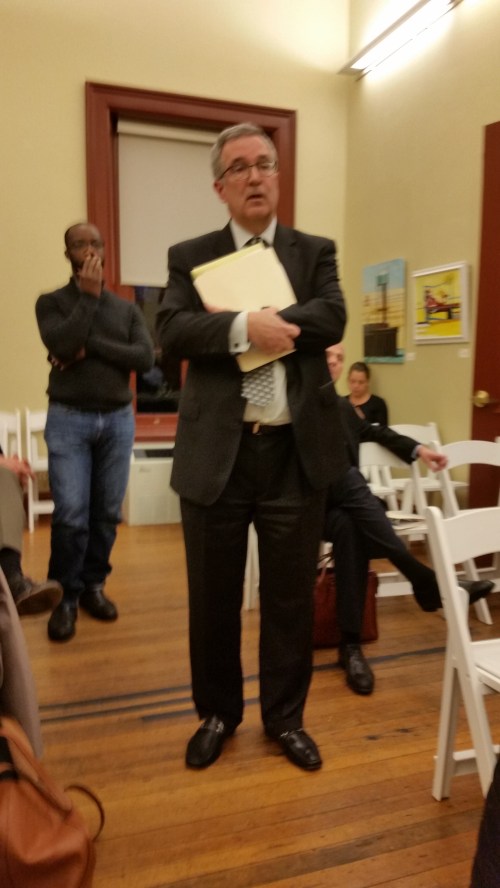 One of  Beuchert's managers (rear) reacts to Klein's presentation before the ANC.