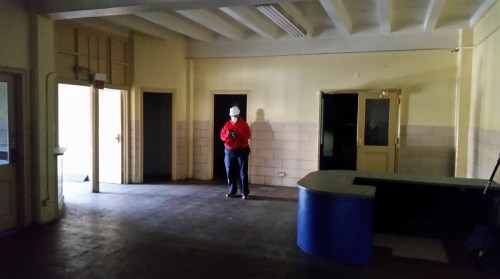 Through the door, you enter the building's lobby.  