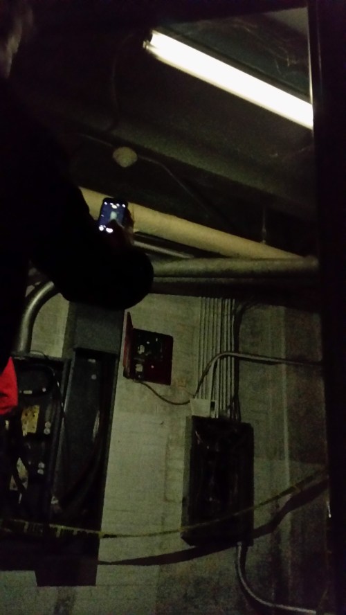 Back down stairs on the south side of the building to the lower levels, the group came upon the creepy single light on in the building - a dim florescent - leaving city engineers puzzled.  