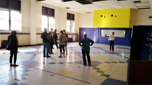 To the auditorium and theater on the north end, above the swimming pool. 