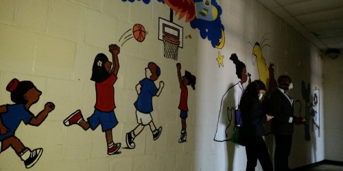 The wall opposite the famous autographs show one of several murals decorating the walls which speak to the former activities of the facility. 