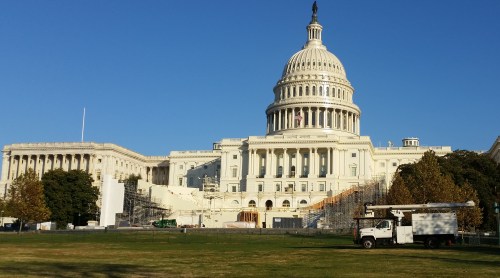 The Architect of the Capitol continues construction of the Inaugural Platform on the West Front of the U.S. Capitol. The slender structure seen against the shadow center left, is the center camera stand for the pool television cameras, the pool still photographers, and the official video and still photographers. The steel scaffolding to the left will support covered broadcast positions for radio and social media news personnel. The steel scaffolding to the right will support tiers of television cameras above, and more live radio broadcast and social media positions below. The wooden framing to the lower right of the center camera stand marks the location where the President will take to oath of office. (Click to enlarge)