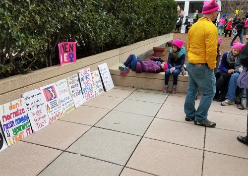 A young marcher reflects at the Department of Energy plaza.