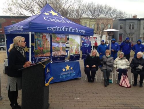 The  Capitol Hill Business Improvement District (BID) held an unveiling ceremony February 2nd at the Eastern Market Metro Plaza.  Four winners (seated) from left to right, Linda Norton, Tara Hamilton, Elizabeth Eby, and Kay Fuller.  At left, BID President Patty Brosmer.